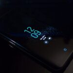 Turned-on Black Samsung Android Smartphone Displaying Clock at 12:09
