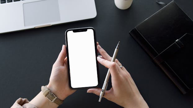 Person Holding Black Iphone and Pen